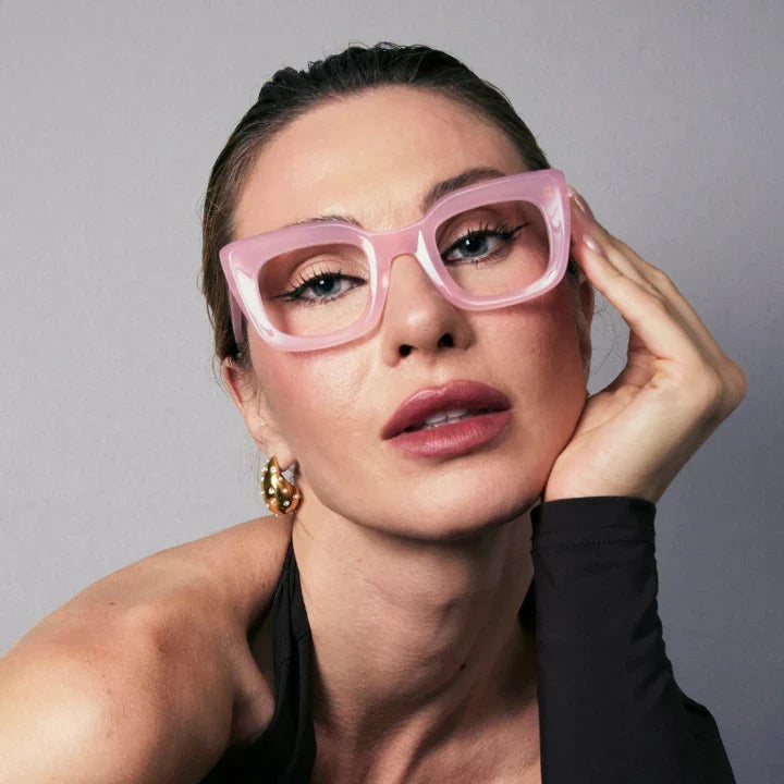Confident woman wearing pink Sofia cat-eye progressive glasses from Vicci Eyewear.