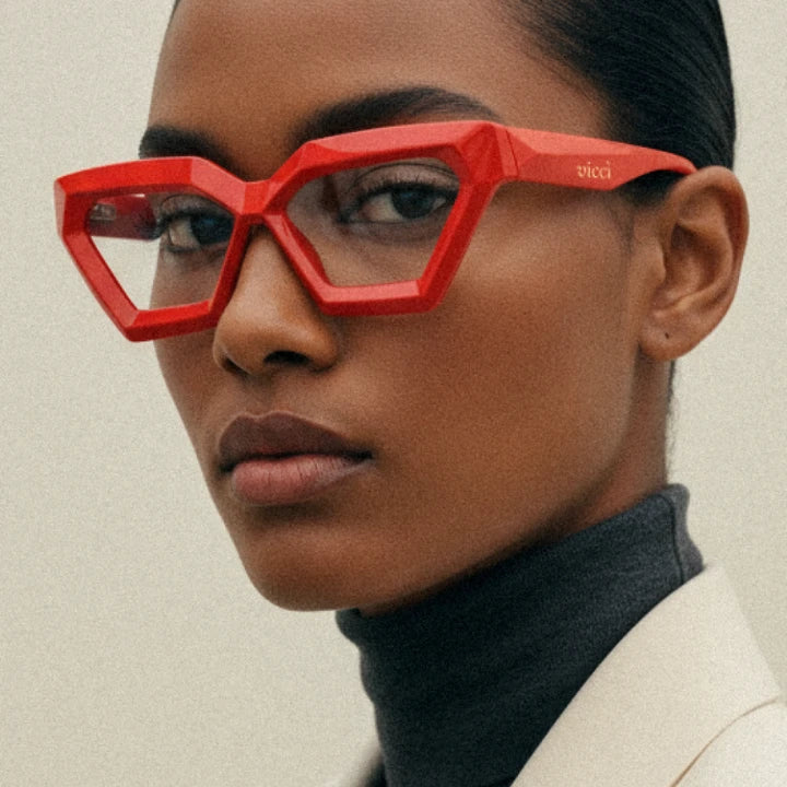 Woman wearing bold red designer glasses from Vicci Eyewear, showcasing stylish Black Friday glasses deals on premium frames.
